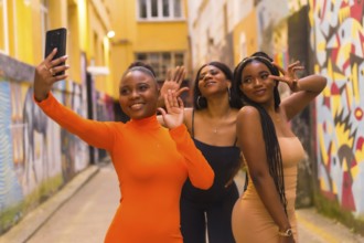 San Sebastián, Gipuzkoa Spain, February 2021: Three girls taking a selfie. Fashionable urban style