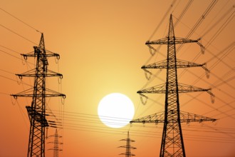 Overhead power lines, high-voltage pylons, power lines, setting sun, sunset, Baden-Württemberg