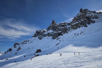 View of a ski resort piste with people skiing in Dolomites in Italy. Ski area Arabba. Arabba,