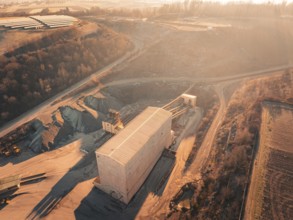Overview of a quarry with buildings in hilly surroundings at dusk, Magstadt, Germany, Europe