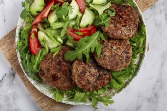 Fried cutlets, mixed minced meat, with vegetable salad, homemade, top view, no people