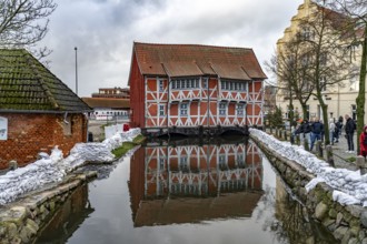 Half-timbered building vault over the round pit or mill stream in the historic old town, Hanseatic