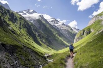 Hiker on hiking trail, view of Großer Schober and Rötspitze, Umbaltal, Hohe Tauern National Park,