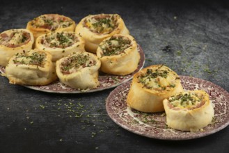 Freshly baked dough snails served on decorative plates