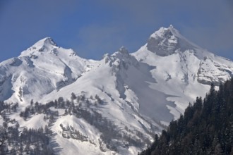 Snow-covered peaks of the Bernese Alps rise out of the fog, Bernese Alps, near Ovronnaz,