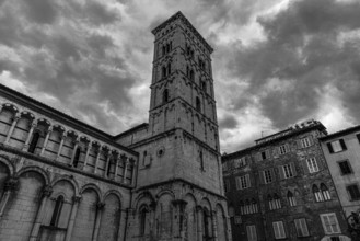Dark rain clouds over the bell tower of the church of San Michele in Foro, historic city centre,