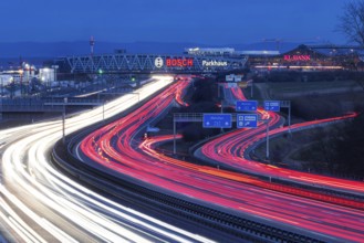 A8 motorway at Stuttgart Airport in the evening. Heavy traffic, lanes of light. Modern architecture