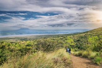 Nature trail overlooking a distant volcano. Landscape of a dirt road overlooking Masaya Lagoon