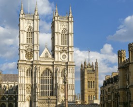 Towers and frontage of Westminster abbey church with Victoria Tower in background, Westminster,
