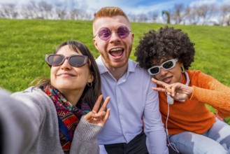 Three happy multi ethnic friends are taking a selfie while making the peace sign, enjoying a sunny