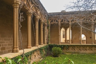 Ivy growing on columns in the gothic style gallery of the palace of the kings of navarre of olite