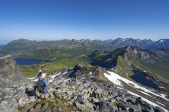 View of mountains and fjord landscape, mountain panorama, mountaineer at the summit of Rundfjellet,