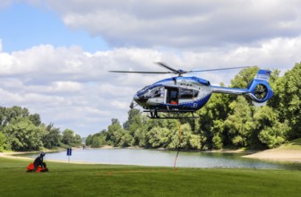 Airbus H 145 police helicopter during an operational exercise with BAMBI BUCKET extinguishing water