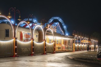 Festively illuminated circus with blue arches and lights that radiate a festive atmosphere,