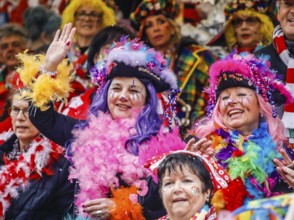 Colourfully costumed carnivalists celebrate carnival in Cologne, on Weiberfastnacht the street