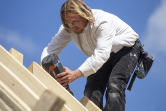Carpenters working on the roof of a new building in the Rhein-Pfalz district