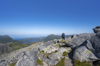 View of mountains and fjord landscape, mountain panorama, mountaineer at the summit of Rundfjellet,
