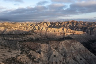 Sunrise, wide hilly desert landscape with dry vegetation, Gorafe desert, semi-desert, Granada,