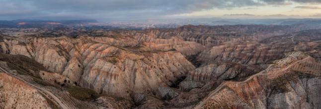 Sunrise, wide hilly desert landscape with dry vegetation, Gorafe desert, semi-desert, Granada,
