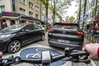 Cycling in the city, inner-city street, cycle lane, bicycles have priority, two-lane traffic with