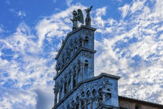 Facade of the church of San Michele in Foro, above the large bronze statue of the Archangel