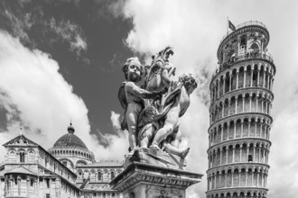 Statue with angels, behind the Cathedral of Santa Maria Assunta and the Leaning Tower, black and