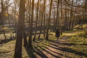 A young woman walking through the natural park of the town of Pasaia Antxo, Basque Country