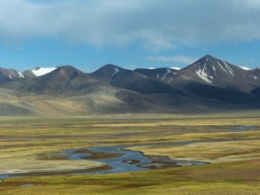 Mountain landscape and wide plain with river, highlands of Tibet, China, Asia
