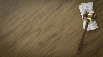 Overhead of gavel resting on a table and stacks of thousands of dollars with room for text