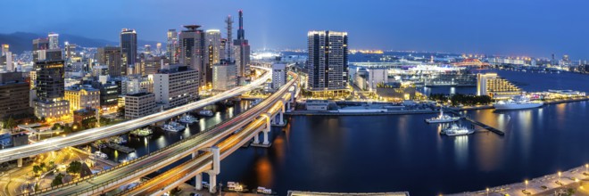 Kobe skyline from above with harbour and elevated road panorama at night in Kobe, Japan, Asia