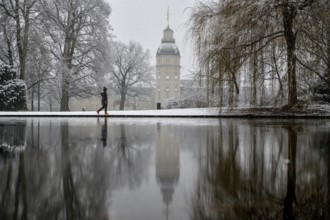 Karlsruhe castle reflected in a pond in the castle garden, Karlsruhe, Baden-Württemberg, Germany,