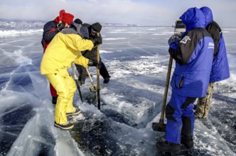 Digging a hole in the ice for scuba diving, Lake Baikal, Olkhon Island, Pribaikalsky National Park,
