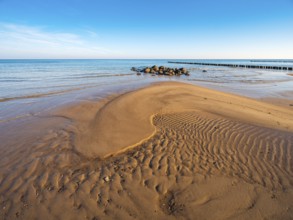 Pristine beach on the Baltic Sea with groynes, sandbank, boulders and sand ripples, Baltic resort