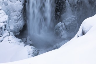 Dettifoss waterfall with icy and snow-covered rock face, Northern Iceland Eyestra, Iceland, Europe