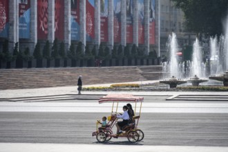 Family in a rickshaw on Ala-Too Square, in Bishkek, Kyrgyzstan, Asia