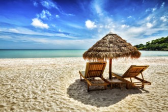 Vacation holidays background wallpaper, two beach lounge chairs under tent on beach. Sihanoukville,