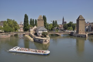 Excursion boat on the River Ill at the Ponts Couverts bridge with towers, UNESCO World Heritage