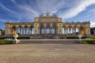 A majestic gloriette with decorative elements and visitors, Vienna
