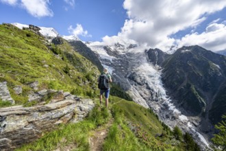 Mountaineer in front of impressive mountain landscape with glacier, view of glacier Glacier de