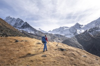 Hiker on hiking trail, snow-covered mountains, Ötztal, Tyrol, Austria, Europe