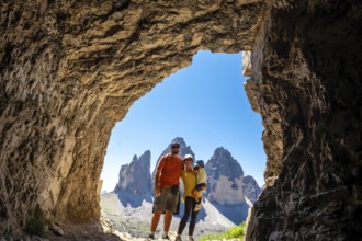 Family enjoying breathtaking view of tre cime di lavaredo, dolomites, italy, during summer hike,