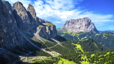 Breathtaking summer landscape in the dolomites, featuring a winding road through lush green valleys