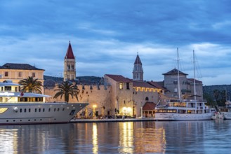 Cruise ships in front of the old town centre of Trogir at dusk, Croatia, Europe