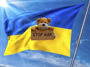 Symbolic picture, Ukraine flag in front of a bright sky, sad little bear with Stop War sign, Donald