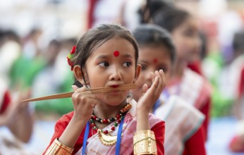 A girl plays Gagana (musical instrument) as she participate in a Bihu dance workshop, ahead of