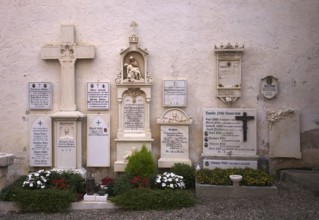 Cemetery, graves, crosses in front of the pilgrimage church Parish Church of Our Lady of Sorrows,