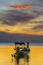Longtail boat in sunset, sunset, horizon, evening light, boat, sun, evening mood, cloudy sky,