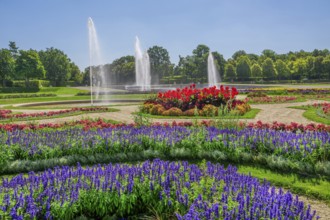 Garden parterre at the New Palace with flowerbeds and fountain in the Schleissheim Palace complex,