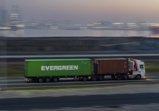 Lorry on the road from Euromax Terminal Rotterdam, ENECO wind farm on the dike around the port of