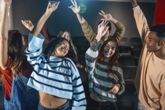 Friends are dancing and having fun at a movie disco event inside a cinema, enjoying music and the